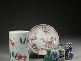 a group of vases and a plate on a table