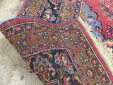 an image of a rug laying on the ground next to a pair of scissors