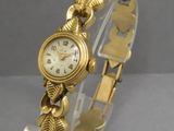 an image of a close up of a wrist watch on a clear stand