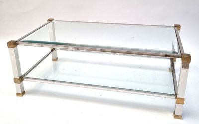 a glass coffee table with a metal base and a glass top