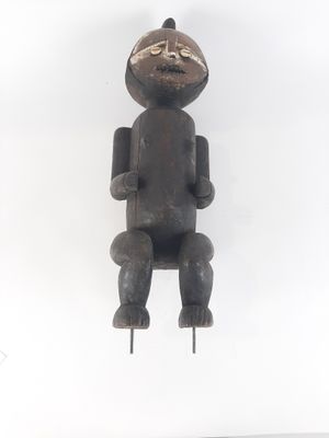 wooden sculpture of a person sitting on a chair with a white background
