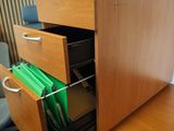 un bureau avec un classeur et une chaise dans la pièce