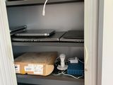 a closet with laptops and other electronic equipment in it