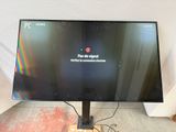 a computer monitor sitting on top of a wooden stand