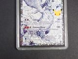a pokemon card in a plastic case on a table