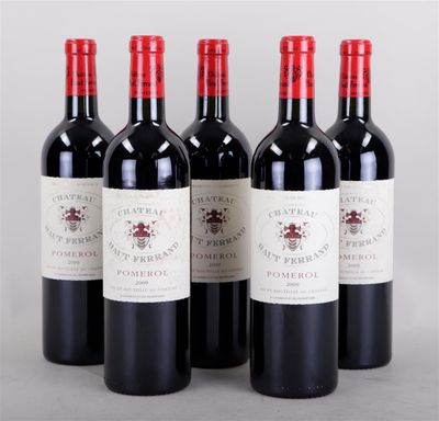 four bottles of red wine are lined up in a row