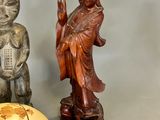 two asian figurines sitting next to each other on a table