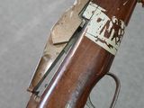 an old rifle with a wooden handle and a metal handle
