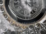 a close up of a clock that is on a table