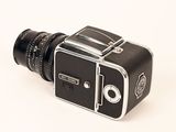 a black and silver camera on a white surface