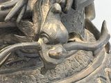 a large metal vase with a dragon on it