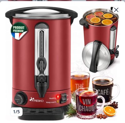 an image of a red electric coffee maker with a cup of tea and orange slices
