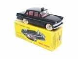 a black toy car sitting on top of a yellow box