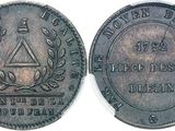 a close up of a coin on a white surface
