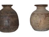 two vases sitting next to each other on a white surface