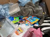 a cardboard box filled with baby items and a bottle of water