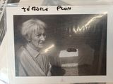 a black and white photo of a woman holding a piece of cake