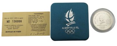 une image représentant une pièce de monnaie et un billet sur lequel figure le logo olympique