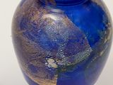 a blue vase with a gold and blue design on it
