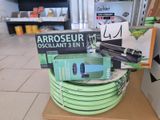 a stack of green hoses sitting on top of a cardboard box