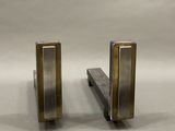 a pair of metal bookends that are on a table