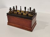 an old wooden box with a bunch of tools on top of it