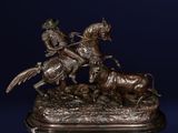 bronze statue of a man on a horse and a cow