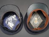 two hats that are sitting side by side on a table