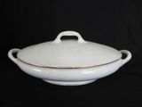 an image of a white bowl with a gold rim on a black background