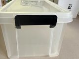 a large white box with a black lid on the floor