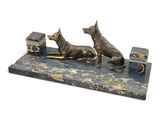 statue of a pair of dogs on a marble base with a box