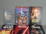 several star wars books sit on a table next to each other