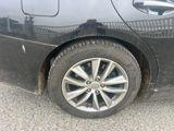 a close up of a black car with a flat tire