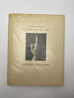 an old book with a picture of a hand on it