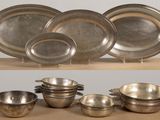 five bowls and two bowls sitting on a shelf
