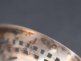 a close up of a silver spoon with writing on it