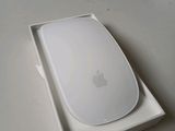 a white apple mouse in a white box on a table
