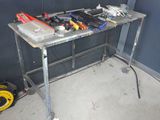 une table sur laquelle sont posés des outils, dans un coin de la pièce