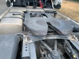 a truck that has a flat bed with a large rock in the back of it