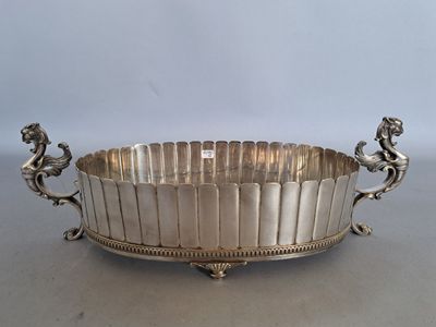 a large silver plate with two lions on the sides of it