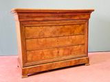 an image of a wooden chest of drawers on a pink floor