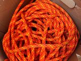 an orange rope in a box with a white tag on it
