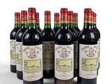 six bottles of wine are lined up in a row on a white surface
