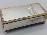 an antique silver box with a picture of a man and woman on it