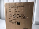 a cardboard box sitting on a table with a sticker on it
