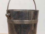 an old metal bucket sitting on top of a wooden table