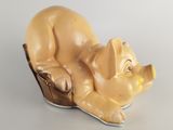 a figurine of a dog laying down on a table