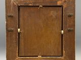 an old wooden picture frame sitting on top of a white surface