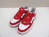 red and white sneakers with red laces are on a white surface