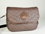 a brown purse that is sitting on a white table
